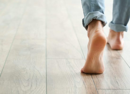 Man walking on new laminate flooring at home