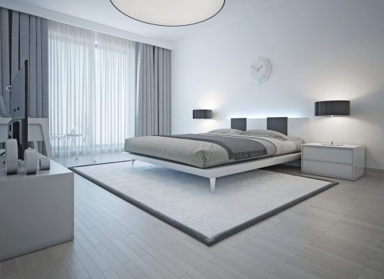 Spacious contemporary styled bedroom with double bed, white carpet and light grey walls and furniture. 3D render